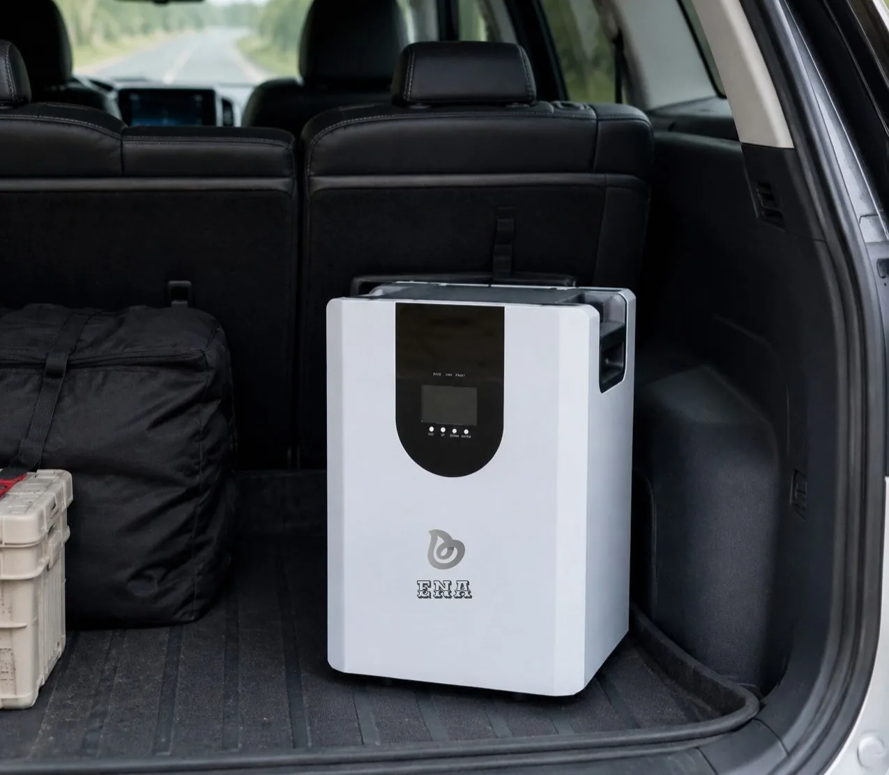 An ENA hybrid inverter and storage unit standing in the load space of a vehicle, ready to be carried to site
